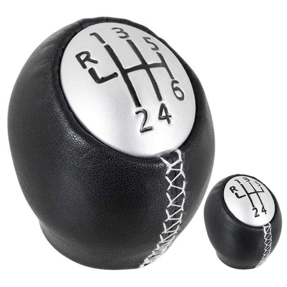 Fekete színű, bőrözött 5 és 6 sebességes Dacia váltógomb. Ezüst színű számlappal, fehér varrással.