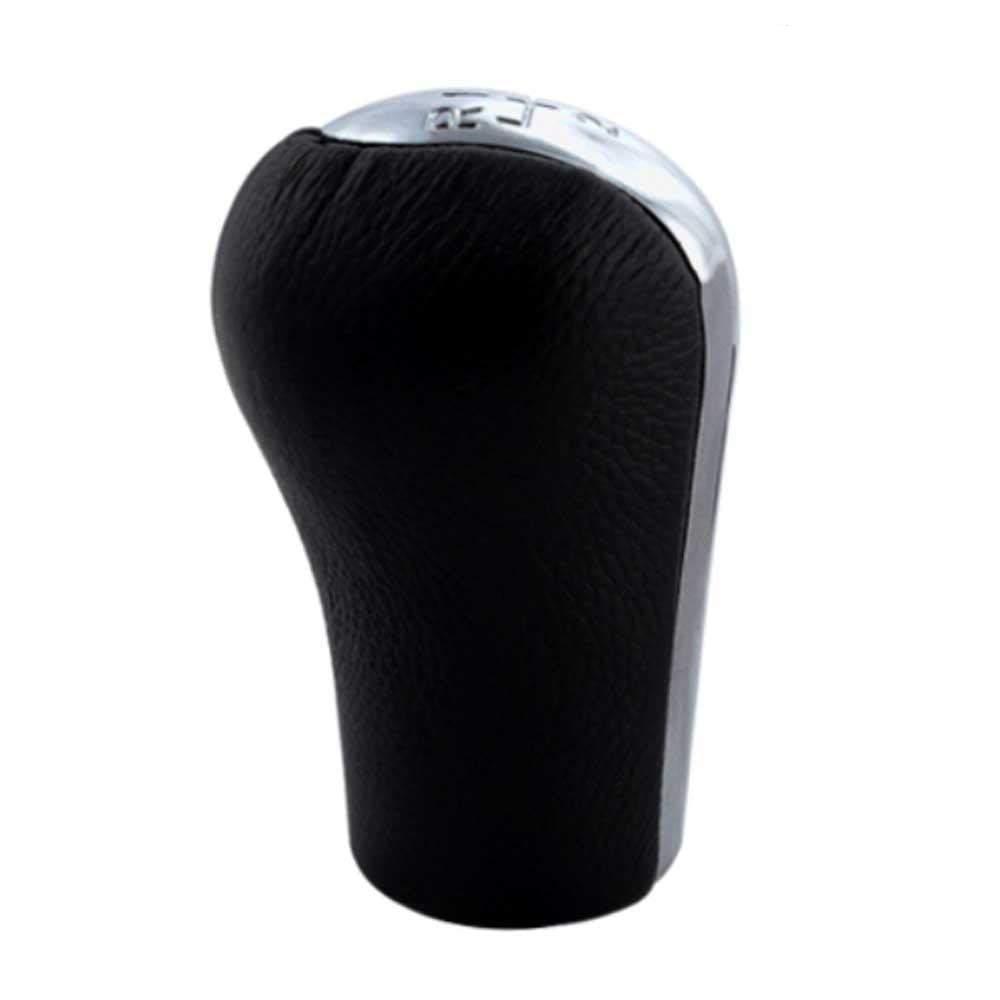 Fekete színű, bőrözött 5 sebességes Toyota váltógomb. Krómozott számlappal.