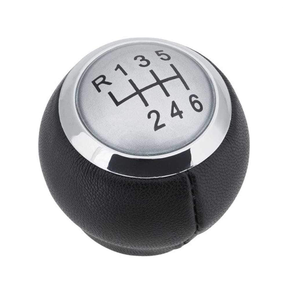 Fekete színű, bőrözött 6 sebességes Toyota váltógomb. Ezüst színű számlappal, króm számlapkerettel.