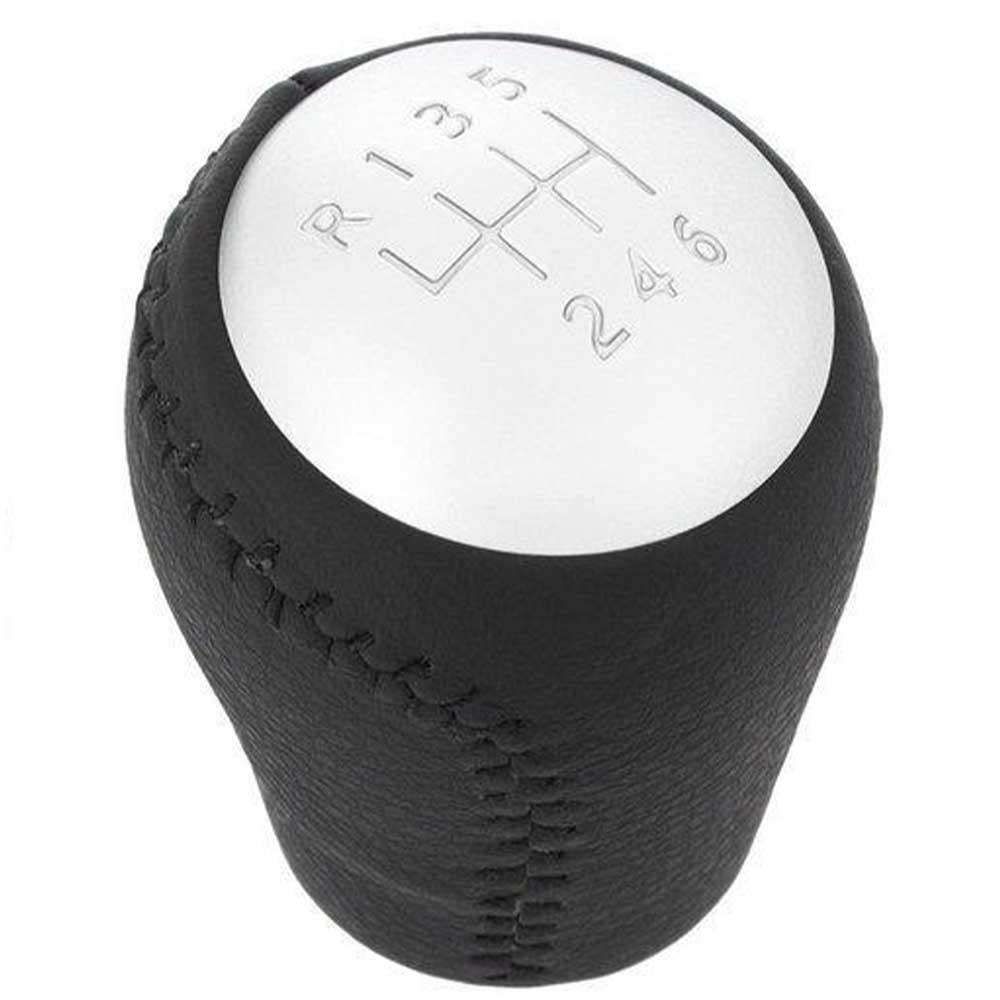 Fekete színű, bőrözött 6 sebességes Nissan váltógomb. Ezüst színű számlappal.