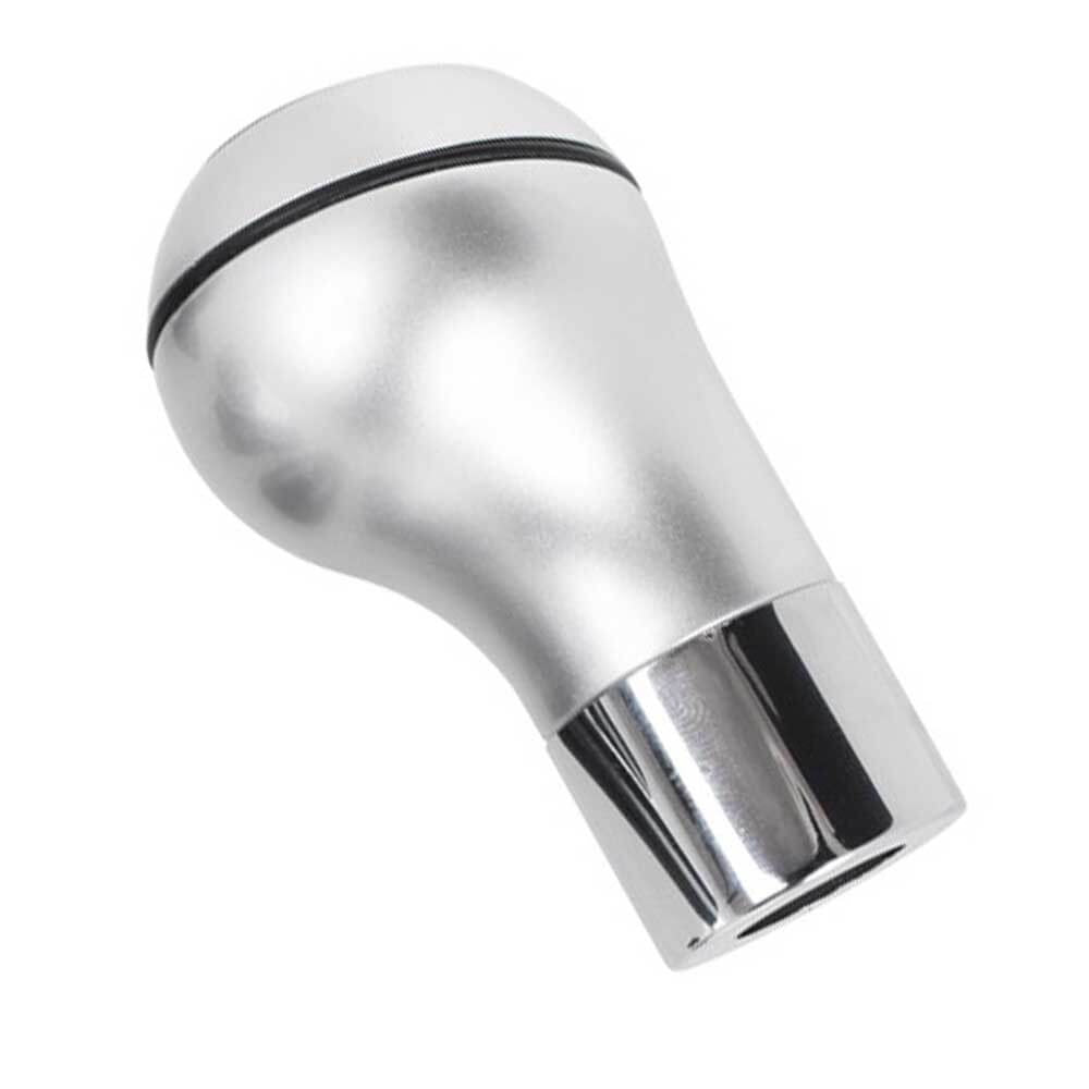 Ezüst-króm színű, 6 sebességes BMW váltógomb.